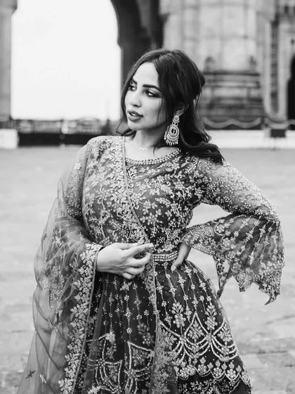 A candid black and white portrait of the bride. Her expression and pose give this photo a classic, high-fashion feel.