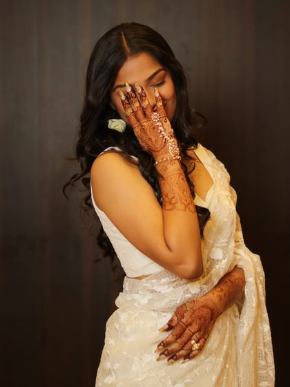 A candid and happy shot where the beautiful, dark mehendi stain on her hands really stands out.