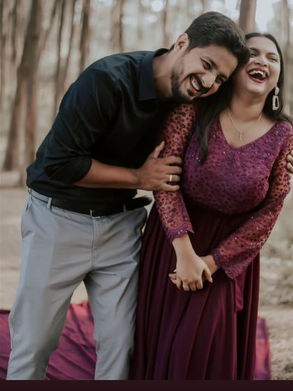 Laughter and love captured in a candid moment. This couple's joy is infectious in their pre-wedding shoot featuring a beautiful wine-colored gown.