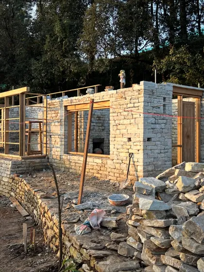 The sun sets behind the mountains as our team continues their work on the stone and timber structure. The dedication of the artisans allows us to make progress even in the most remote and challenging conditions.