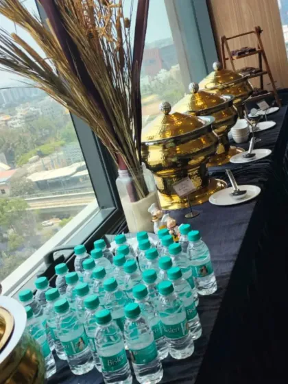 Catering with a view. We can set up a premium buffet experience in any corporate space, like this one overlooking the Bangalore cityscape. Our setup includes everything from hot main courses in our signature chafing dishes to bottled water for convenience.
