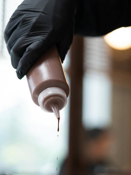 Experimenting with chocolate is our favorite pastime. Here, a chef prepares a chocolate sauce, a fundamental component in many plated desserts.