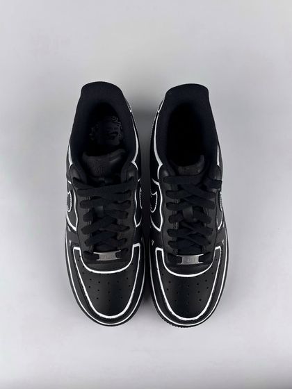 A front view of the black cartoon custom sneakers.