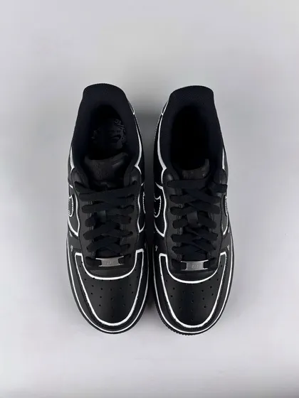 A front view of the black cartoon custom sneakers.
