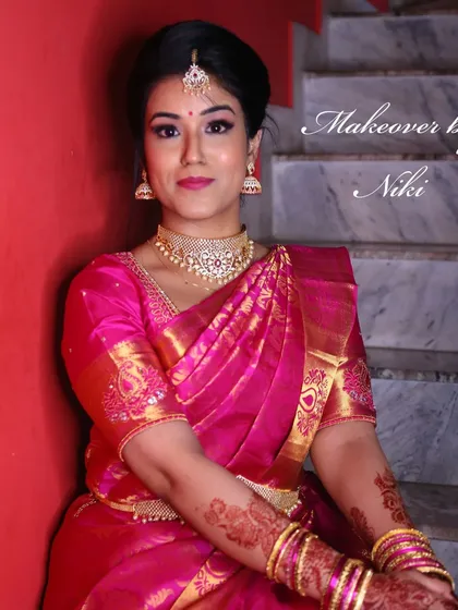 A complete look at Nirosha's engagement style. She wore a vibrant silk saree, and we created a soft glam look with a pretty pink lip and a chic updo.