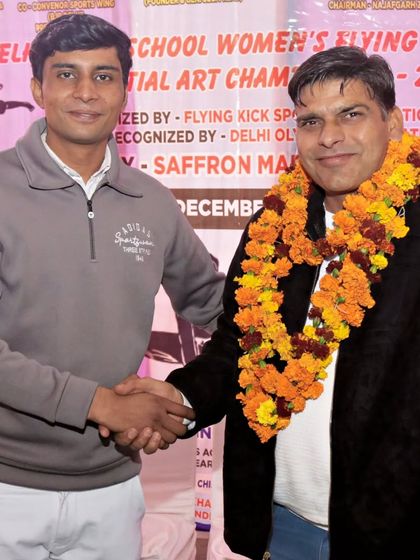 Shaking hands with an official at the Delhi School Women's Flying Kick Sports Martial Art Championship. I support and officiate events for all athletes.