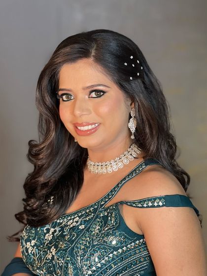 A simple yet elegant American diamond necklace set, as seen on a smiling client. This is a great rental option for when you need a touch of sparkle that isn't too overpowering, perfect for a cocktail party.