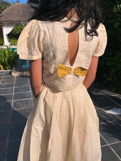 A peek at the back of our checkered two-piece set, featuring a sweet bow detail. It’s these little surprises that make an outfit special.