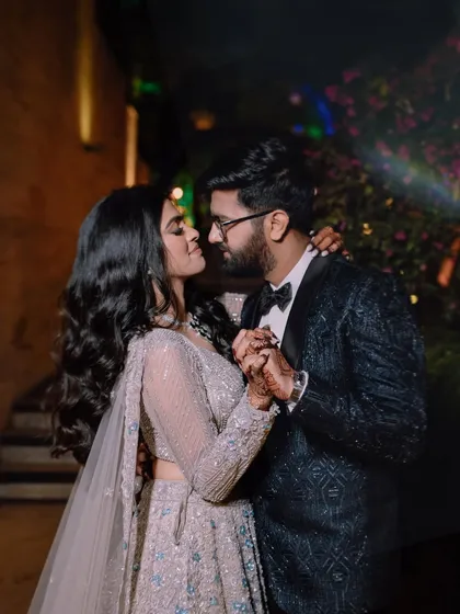 A romantic dance, captured at night. The couple's close embrace and the soft lighting create a very intimate atmosphere.
