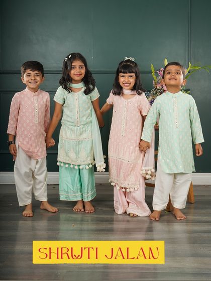Here are two adorable sibling pairs showing off my coordinated pastel sets. The boys wear comfortable kurtas while the girls are in matching sharara sets, all in soft pink and mint green tones.