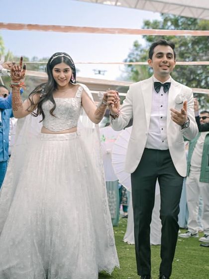 The couple makes their way through a tunnel of ribbons held by their friends and family for a unique and interactive entry.