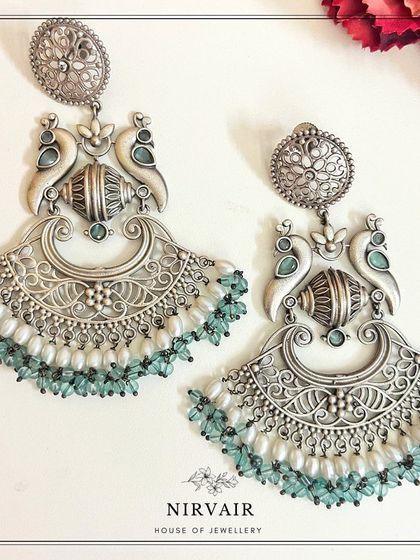 These peacock-inspired replica silver earrings are the kind of unique, eye-catching pieces that shoppers love.