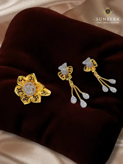 This gold jewellery set, featuring a floral ring and matching drop earrings, combines traditional filigree work with the sparkle of diamonds. It’s a harmonious blend of heritage and modern glamour.