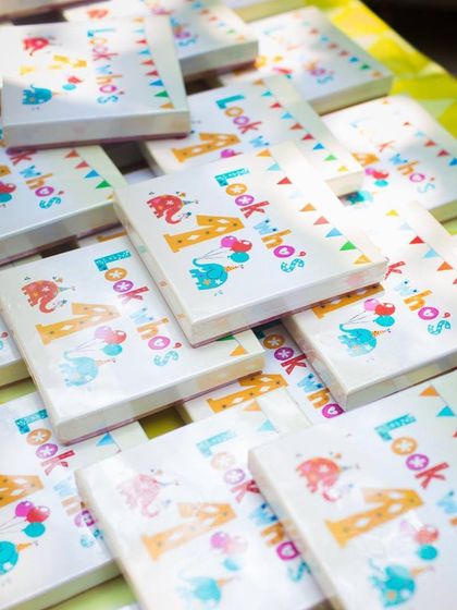 Custom-designed party favors for a vintage circus birthday. The personalized boxes ensure that guests take a piece of the fun home with them.