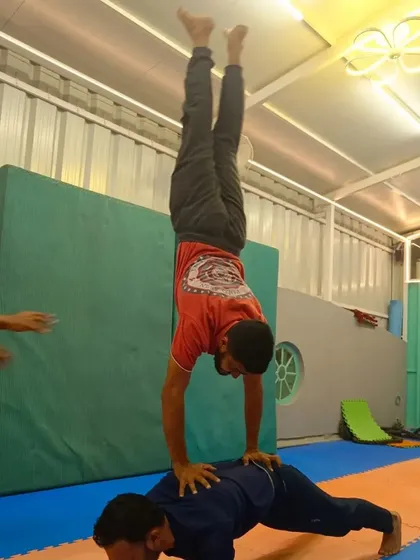 A collection of different partner handstand variations. These exercises range from handstands on a partner's back to one-arm assisted holds, all designed to build strength and teamwork.