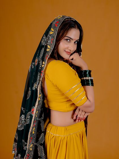 A playful and engaging pose from a studio session. This image shows how I direct models to bring energy and personality to traditional wear.