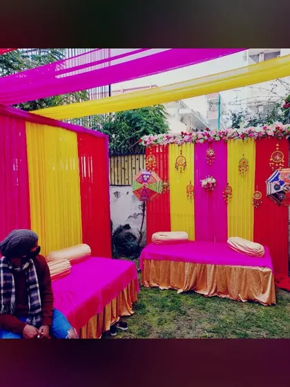The Mehandi seating area, featuring a low diwan with bolsters, set against our colorful backdrop. This provides a comfortable and photogenic space for the main ceremony.