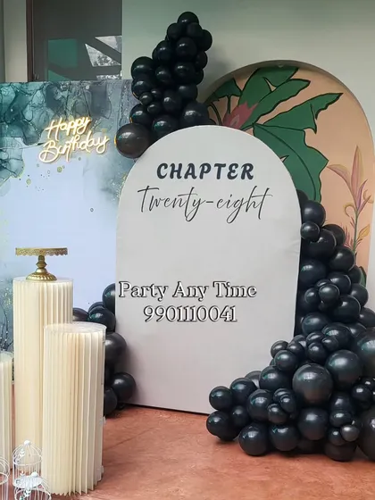 A side view of the modern birthday setup, showing the layered backdrops and balloon placement.