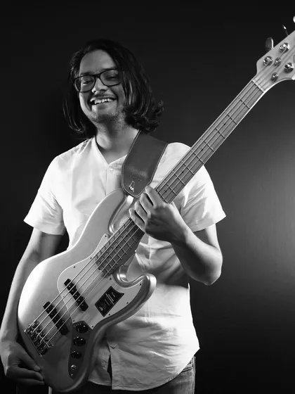 Meet Mikhail, our bassist. He lays down the solid, groovy basslines that you can't help but dance to. His energy and exhilarating fills are a key part of our rhythm section.
