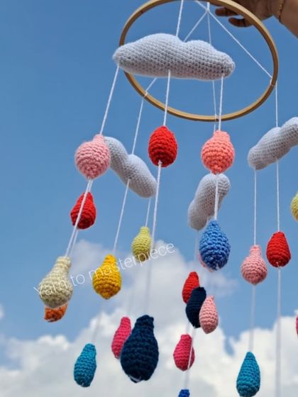 A different angle of the cloud and raindrops mobile, showing the vibrant colors against the sky.