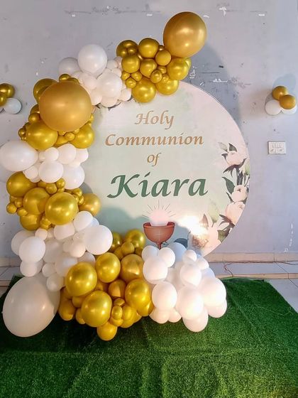 A close-up of the Holy Communion balloon and backdrop decoration.