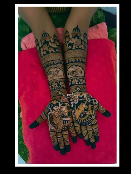The full view of a stunning Maharashtrian bridal mehendi. The arms feature royal elephants and traditional motifs, leading down to the beautiful couple portraits on the palms.