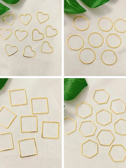 These thin, open-back bezels are ideal for creating delicate pendants or charms. This image shows a variety of shapes including hearts, circles, squares, and hexagons in a gold finish.