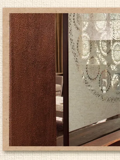 A detail from the Modi Residence showing a hammered copper panel. This highlights our use of traditional metalworking techniques to create rich, tactile surfaces in our interiors.