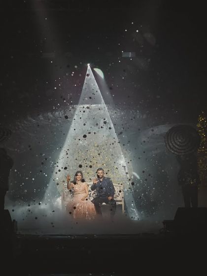 The couple's final pose under a spotlight, with a confetti effect creating a magical, star-filled atmosphere.