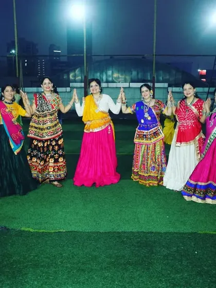 Our lovely ladies showcasing their colorful ghagras and dandiya moves during our outdoor Garba celebration.