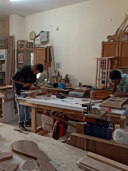 A wide shot of the workshop on a busy day, with sawdust flying and creativity flowing.