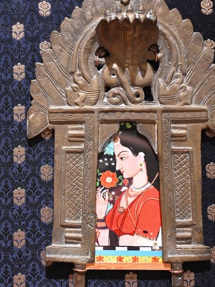 A close-up of the Mughal miniature Prabhavali. The artwork, a digital print on archival paper, is nestled within the intricate brass frame, creating a window into another time.