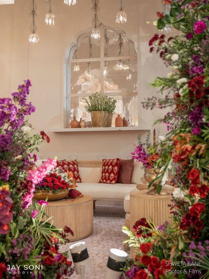 A beautifully framed shot of a lounge setting, seen through a curtain of colorful flowers, highlighting the cozy and inviting atmosphere I aimed to create.