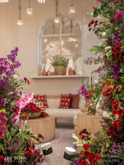 A beautifully framed shot of a lounge setting, seen through a curtain of colorful flowers, highlighting the cozy and inviting atmosphere I aimed to create.