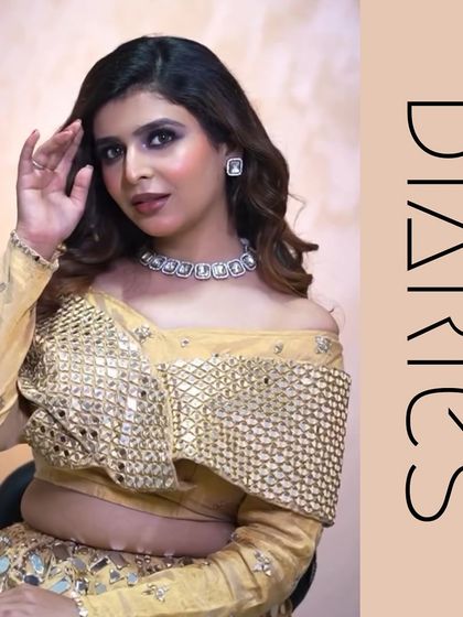 A seated portrait of the smokey eye look. The off-shoulder top and diamond necklace are perfectly complemented by the sophisticated makeup and soft, wavy hair.