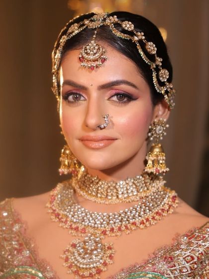 A classic bridal portrait, showcasing the full glory of the layered necklace and matching accessories.