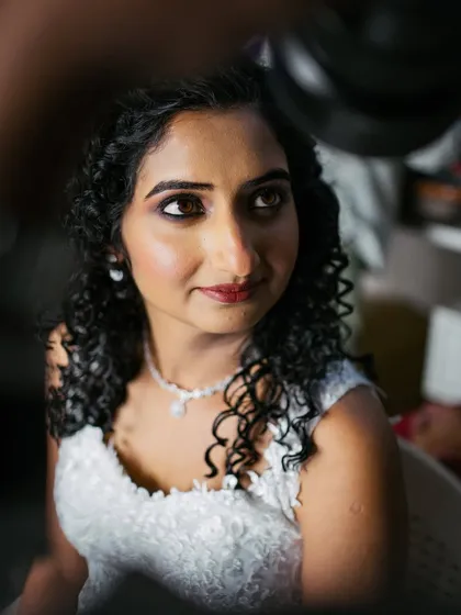 A behind-the-scenes moment during the getting-ready process. The focus was on creating a flawless base and defining her eyes to make them pop.