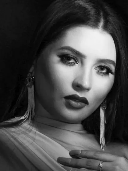 A dramatic pose in black and white, showcasing a bold lip and defined eyes.
