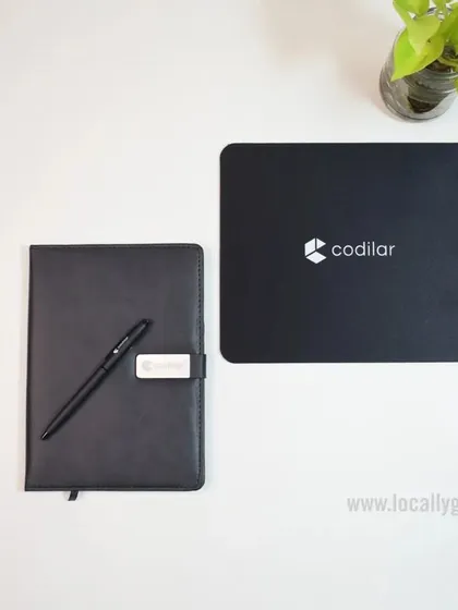 A simple and effective branding solution. This set for Codilar includes a custom mousepad and a matching black notebook with a pen, keeping the brand visible on the desk.