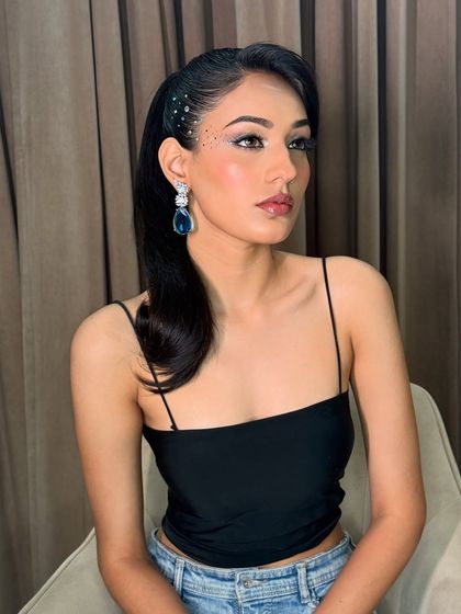 A profile view of the cocktail glam look, highlighting the sleek ponytail and the precise application of the eye makeup.