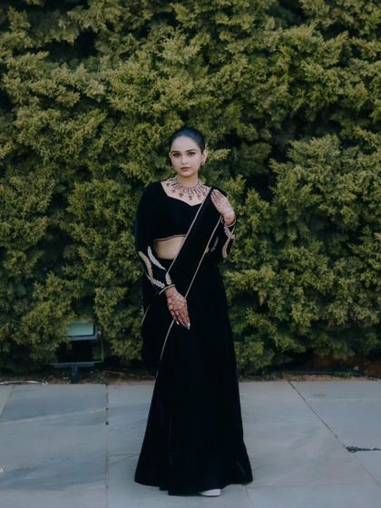 This custom black velvet outfit is perfect for a winter wedding or an evening reception. It's a timeless piece that exudes confidence.