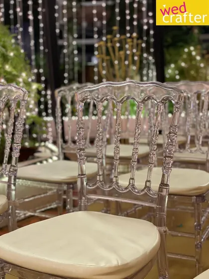 A close-up of the elegant transparent chairs, which add a touch of modern sophistication to the seating arrangement without obstructing the view.