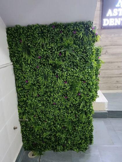 The completed under-staircase green wall, viewed from the bottom. It completely transforms the look of the entryway, making it feel more lush and intentionally designed.