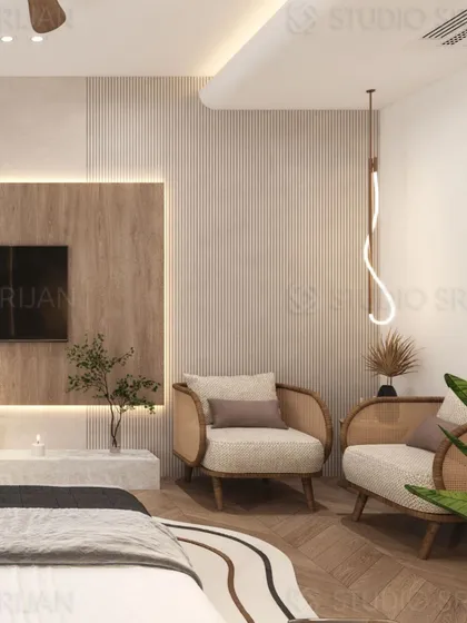 A bedroom in Model Town featuring natural materials, including a TV wall with wood and marble, and cane-back armchairs for a touch of bohemian elegance.