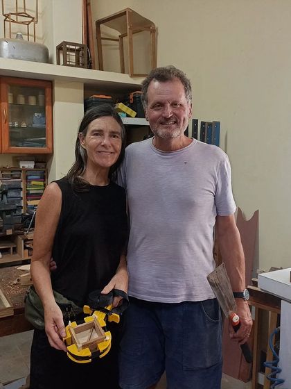 Chris and Shona, a couple traveling through Asia, spent some time in the workshop. Shona is holding a small box she made, while Chris is ready with his tools.