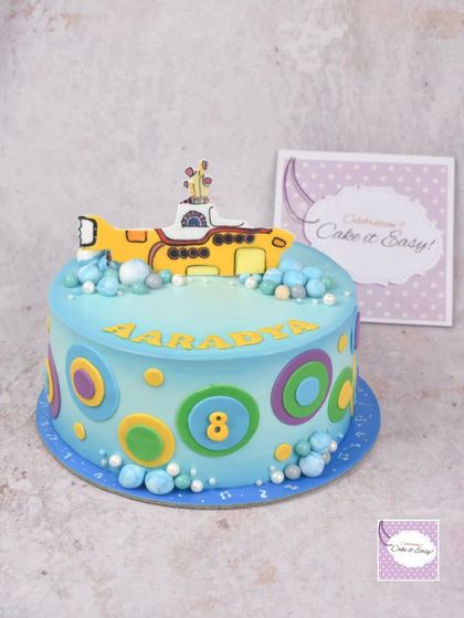The main cake for the Beatles-themed party, featuring the Yellow Submarine and colourful, retro circles.