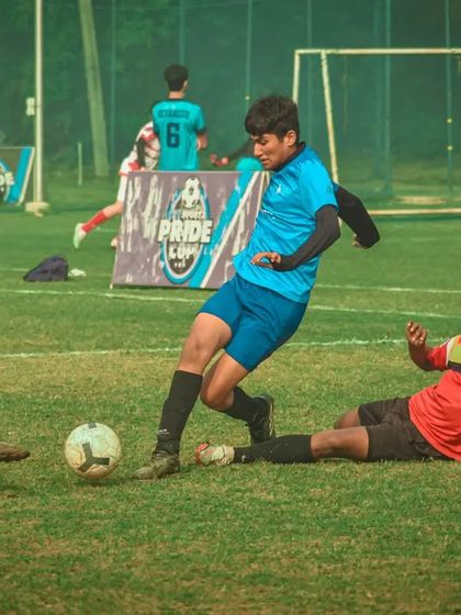 A player slides in for a tackle, trying to win the ball back for his team.