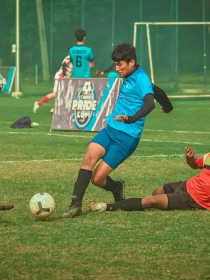 A player slides in for a tackle, trying to win the ball back for his team.