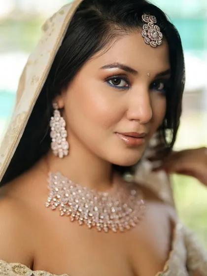 A modern bridal look featuring a pop of blue under the lower lash line. This is a great way to add a subtle, unexpected touch of color to your makeup.