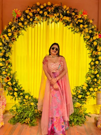 Posing against a stunning floral backdrop at a Haldi ceremony. The bright yellow marigolds created the perfect festive and traditional setting.